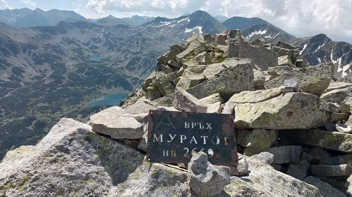Muratov Peak with the sign of the peak in Pirin National Park