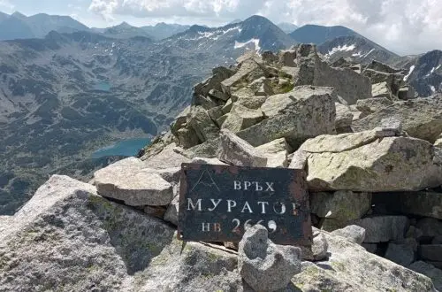 Muratov Peak with the sign of the peak in Pirin National Park