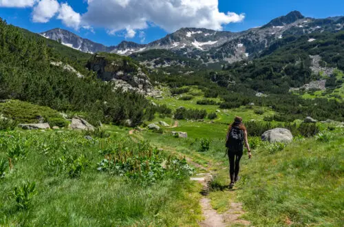 Jessica walking through a field in Pirin National Park