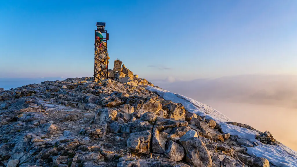 Vihren Peak with sign during sunrise
