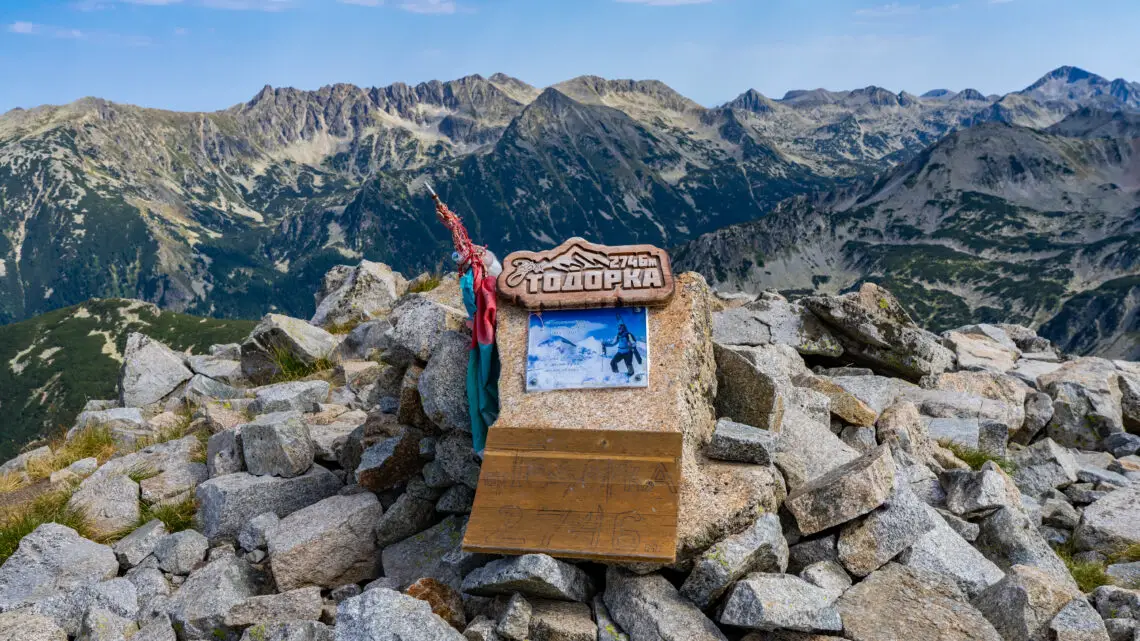 Sign of Todorka Peak with surrounding mountain peaks in Pirin