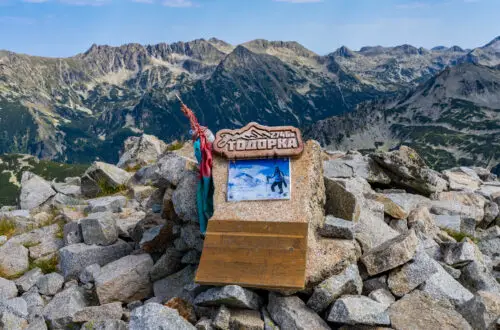 Sign of Todorka Peak with surrounding mountain peaks in Pirin